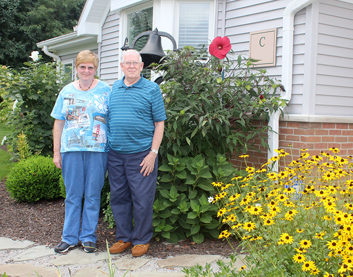 Chapel Hill independent living residents by their flower garden