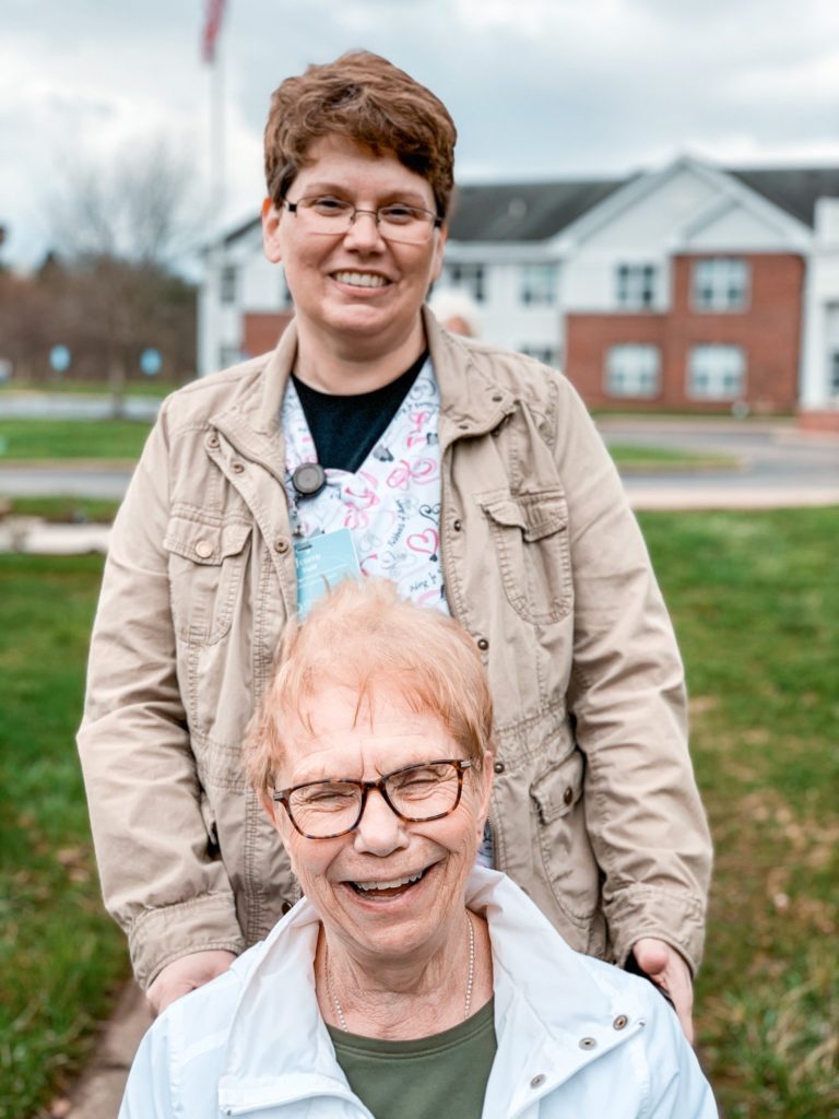 Resident and staff member from The Pines assisted living at The Glenwood Community #LiveIt by going on strolls around the property, sharing laughs.