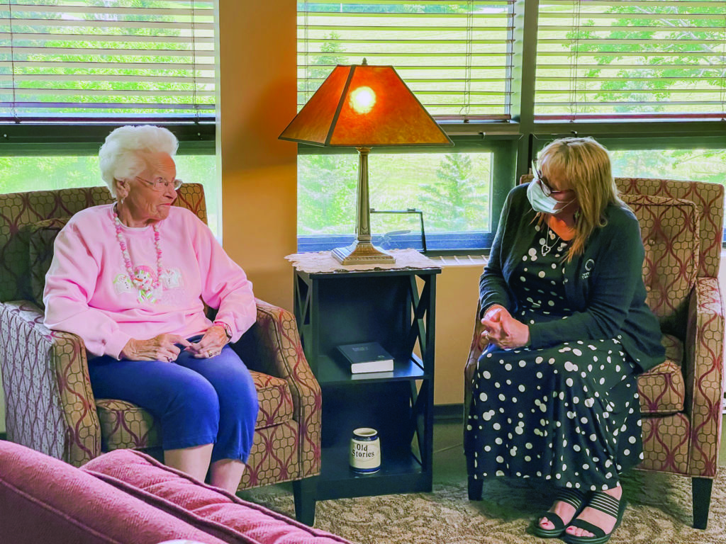 The Chapel Hill Community Executive Director, Deb Durbin sits down in conversation with a resident at the community.