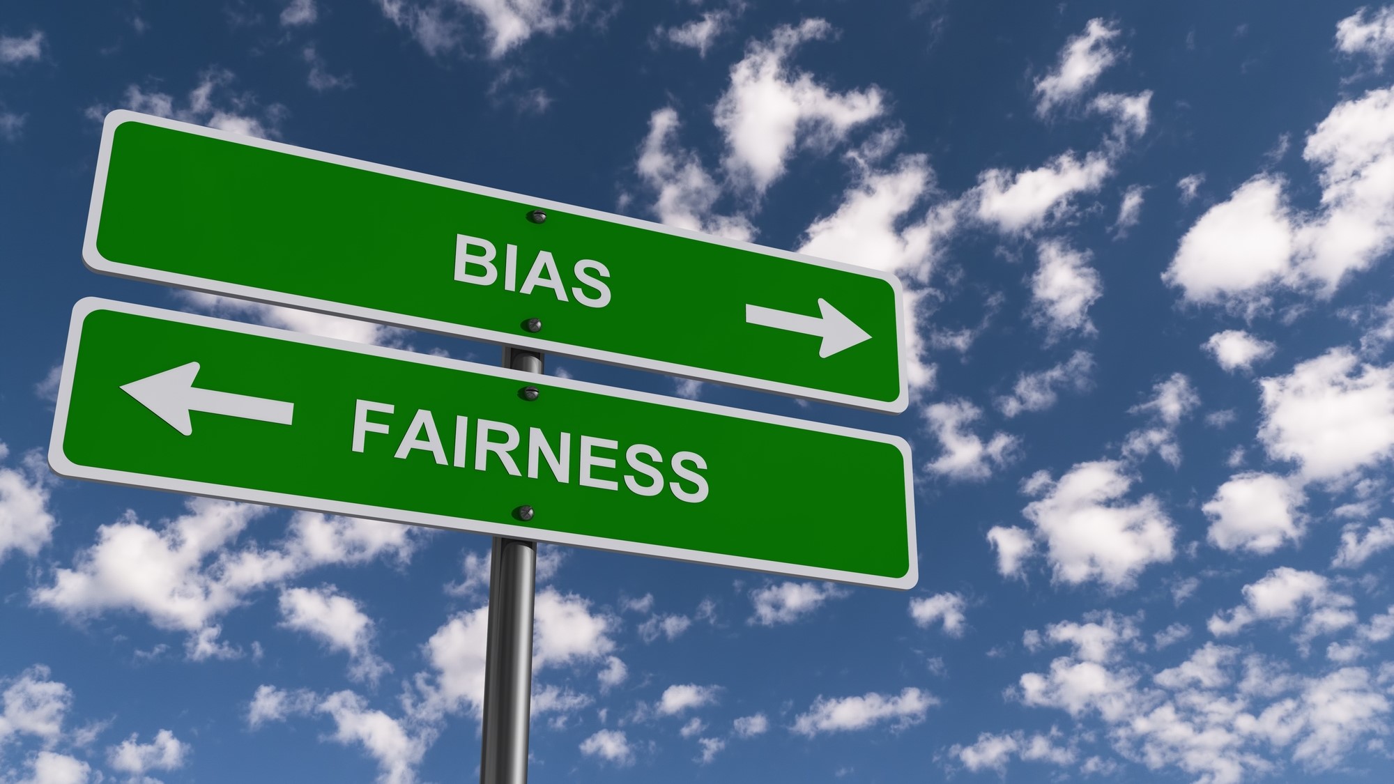 A street sign with green panels points left to "Fairness" and right to "Bias" against a sky with scattered clouds.