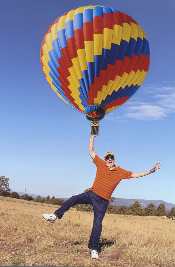 George being pulled away by a hot air balloon. 