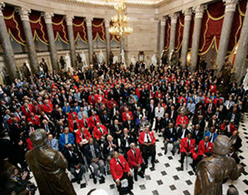 President George W. Bush stands amidst 300 Tuskegee Airmen  in the Statuary Hall of the U.S. Capitol on March 29, 2007.  White House photo by Joyce Boghosian.