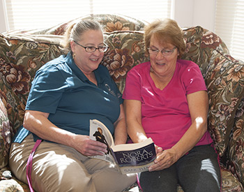 Cindy Southerland (left) with resident Sybil Burdett.